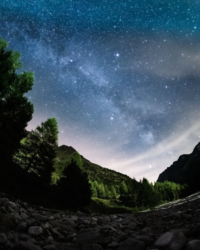 Capture the breathtaking Milky Way over the serene Swiss Alps at night.